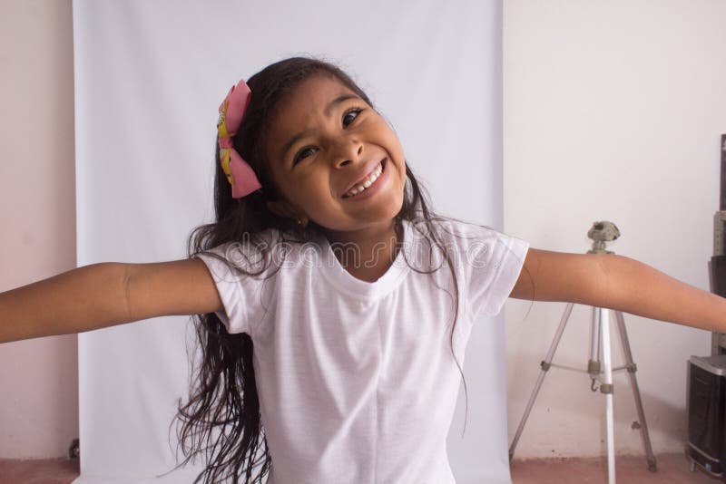 Black girl in white shirt playing, photo with white background, photo with white background.