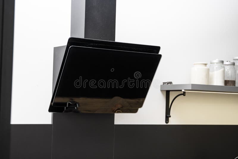Black Glass Kitchen Hood on a Modern Kitchen with a White Walls. Stock