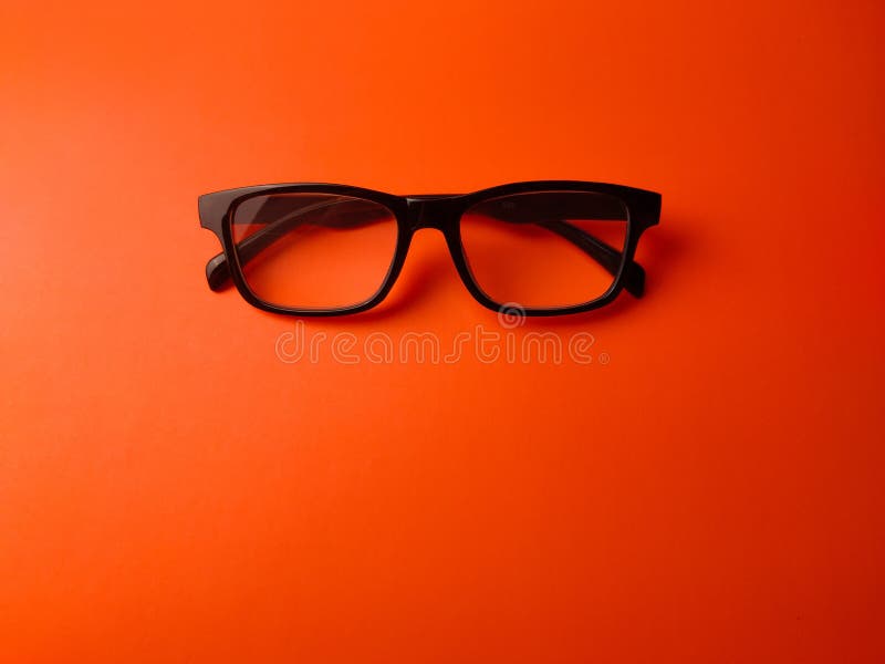 Black glasses on a orange background with copy space stock photo
