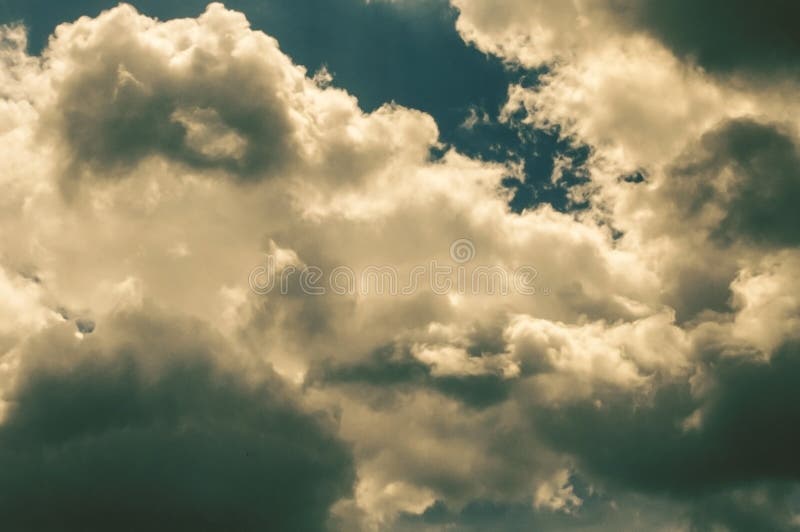 Black gloomy storm clouds with flashes of sunlight royalty free stock image Black gloomy storm clouds with flashes of sunlight royalty free stock image