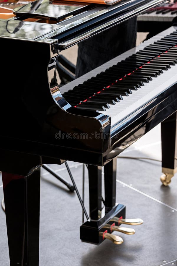 Black Grand Piano with Black and White Keys on Stage Stock Image