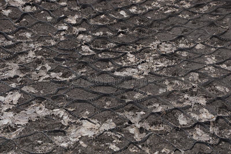 Black gray plastic mesh texture on the ground royalty free stock photography