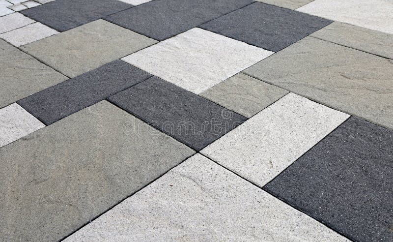 Black, gray and white concrete tiles for outdoor flooring with natural stone effect. Close up royalty free stock photos