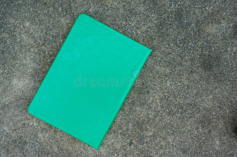 Black green leather notebook or diary on stone background stock photo
