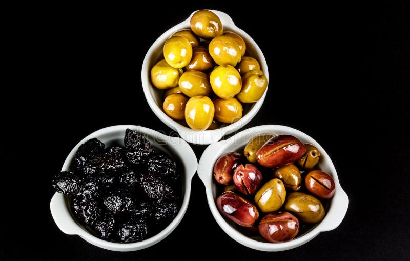 Black, Green, and Pink Olives in Bowls. Stock Photo Image of