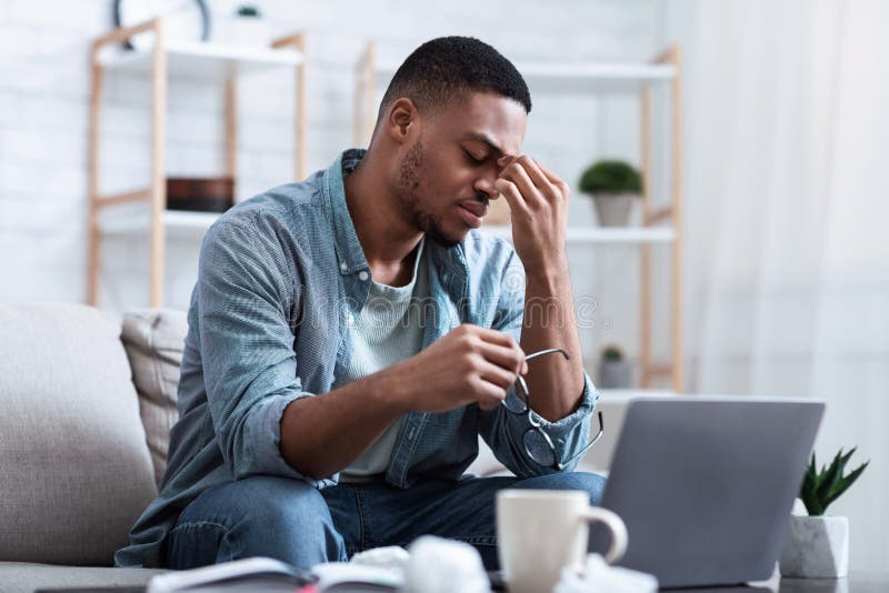 Man Having Eyes Fatigue Tired after Work on Computer Indoors Stock
