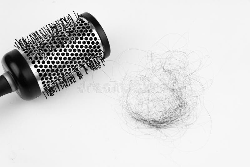 Black Hair Loss Problem with Hairbrush on White Background Stock Photo
