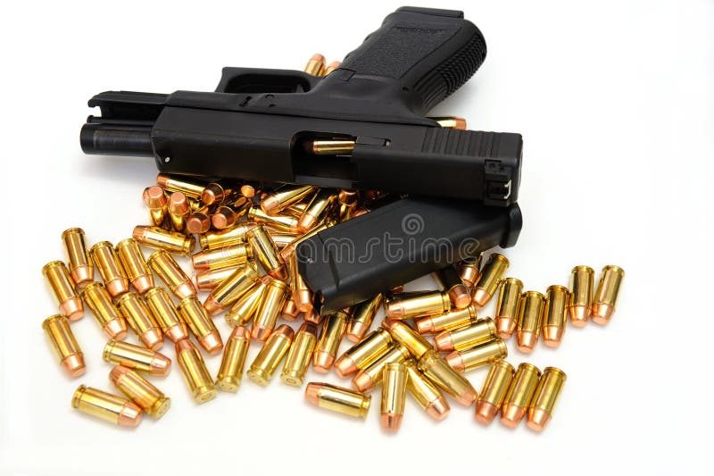 A semi automatic pistol with an extra 10 round magazine, and many .40 caliber brass cartridges. The weapon is locked open showing a cartridge ready to enter the chamber. A semi automatic pistol with an extra 10 round magazine, and many .40 caliber brass cartridges. The weapon is locked open showing a cartridge ready to enter the chamber.