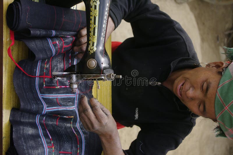 Black Hmong woman sewing machine