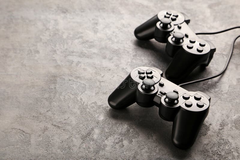 Two Joysticks, Black And White On A Yellow Background. The White And