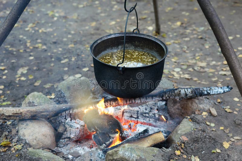 Black kettle with soup stock photo. Image of cooking 16254874