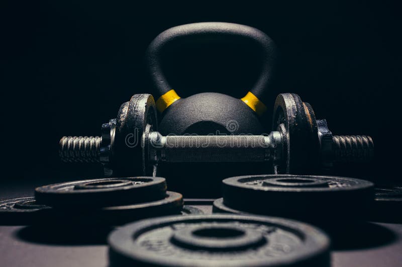 Black kettlebell with yellow marking with free weights and plates royalty free stock image Black kettlebell with yellow marking with free weights and plates royalty free stock image