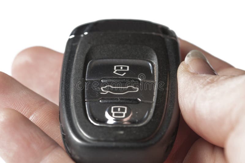 Black Key Of A Car In Hand Isolated On A White Background. Car Key