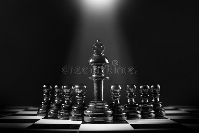 Black king chess standing in front of the pawn chess royalty free stock photography