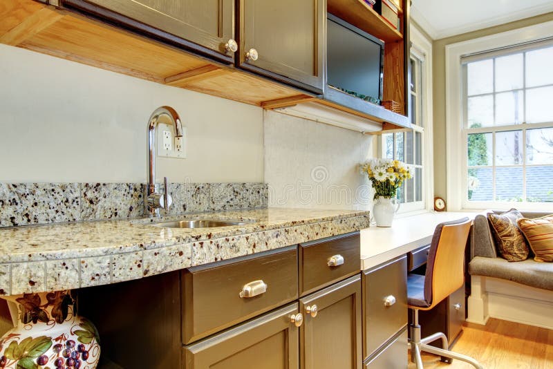 Black kitchen cabinets with marble counter top