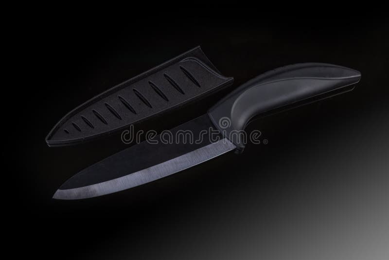Black Kitchen Ceramic Knife and Blade Protector on Dark Surface Stock