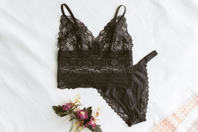 black lace underwear is lying on the light bed. Home erotic lingerie lies on a light background next to the flowers. Home clothes royalty free stock images black lace underwear is lying on the light bed. Home erotic lingerie lies on a light background next to the flowers. Home clothes royalty free stock images