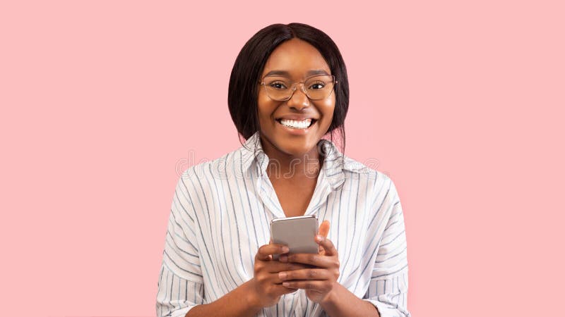 Black Lady Using Mobile Phone Standing On Pink Background, Panorama