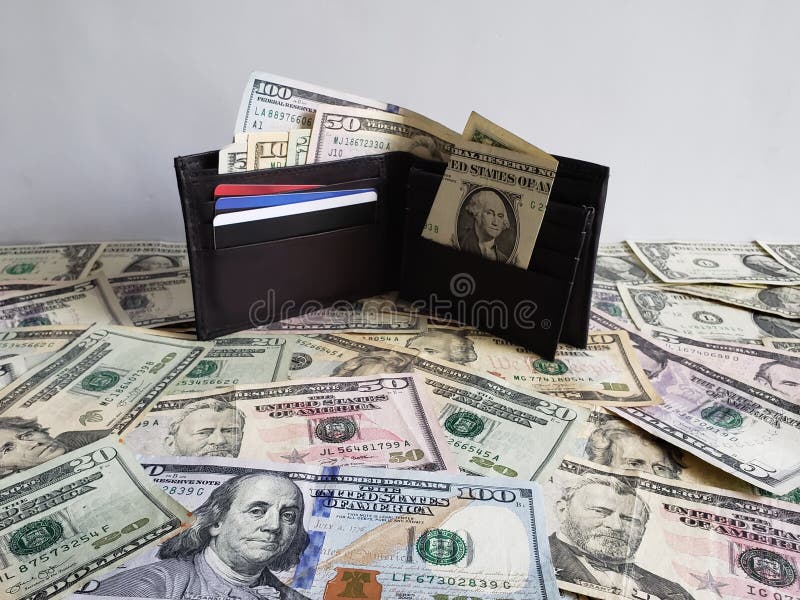 black leather wallet with American dollars bills of different denominations stock photography black leather wallet with American dollars bills of different denominations stock photography