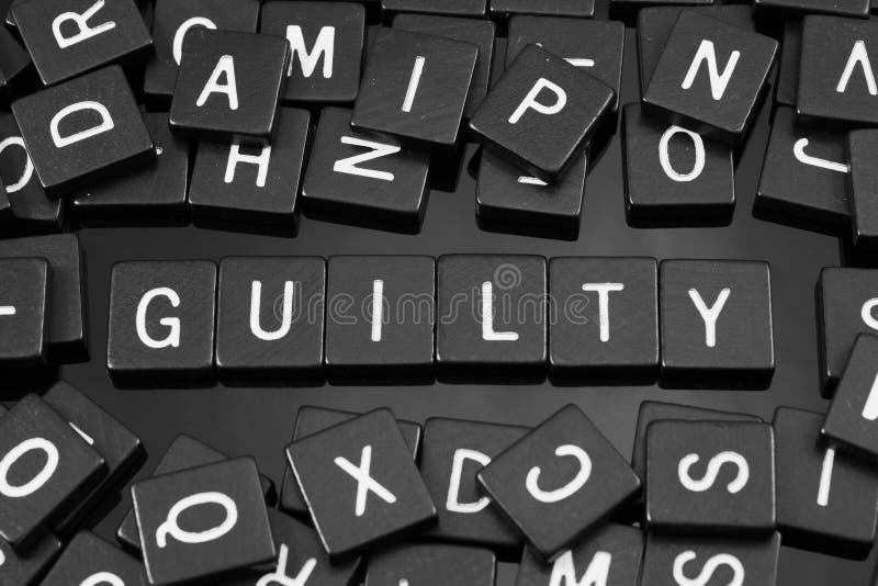Black Letter Tiles Spelling the Word & X22;guilty& X22; Stock Photo