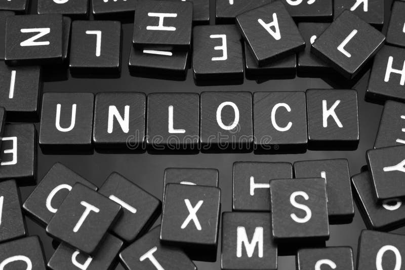 Black Letter Tiles Spelling the Word & X22;unlock& X22; Stock Photo