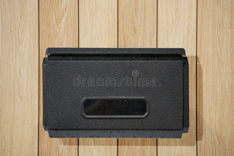 Black mail box in rectangular shape on wall. royalty free stock photo