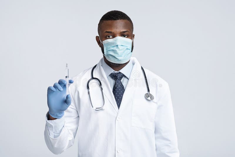 Black Male Doctor in Face Mask Holding an Injection Stock Image - Image ...