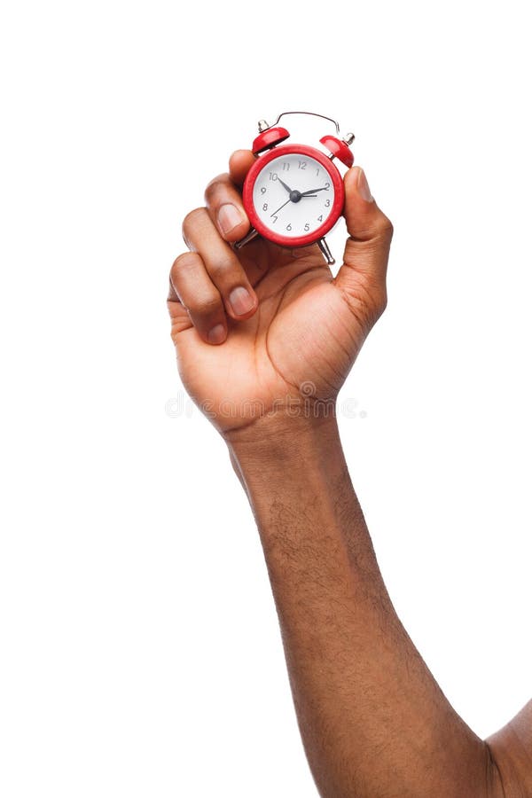 Black male hand holding red alarm clock