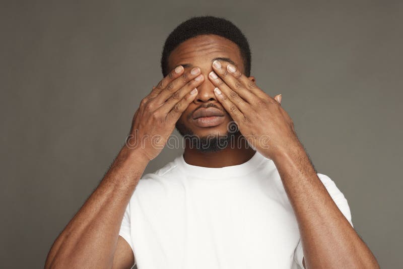 Black Man Covering His Face With Big Clock On White Background Stock