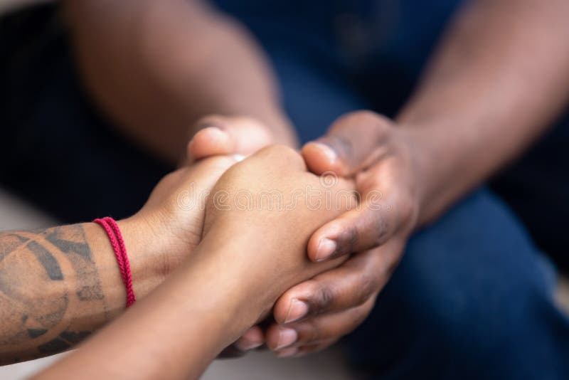 Black men friend holding hands of african woman, american family couple give psychological support, help trust care empathy hope in marriage relationships, comfort honesty concept, close up view. Black men friend holding hands of african woman, american family couple give psychological support, help trust care empathy hope in marriage relationships, comfort honesty concept, close up view