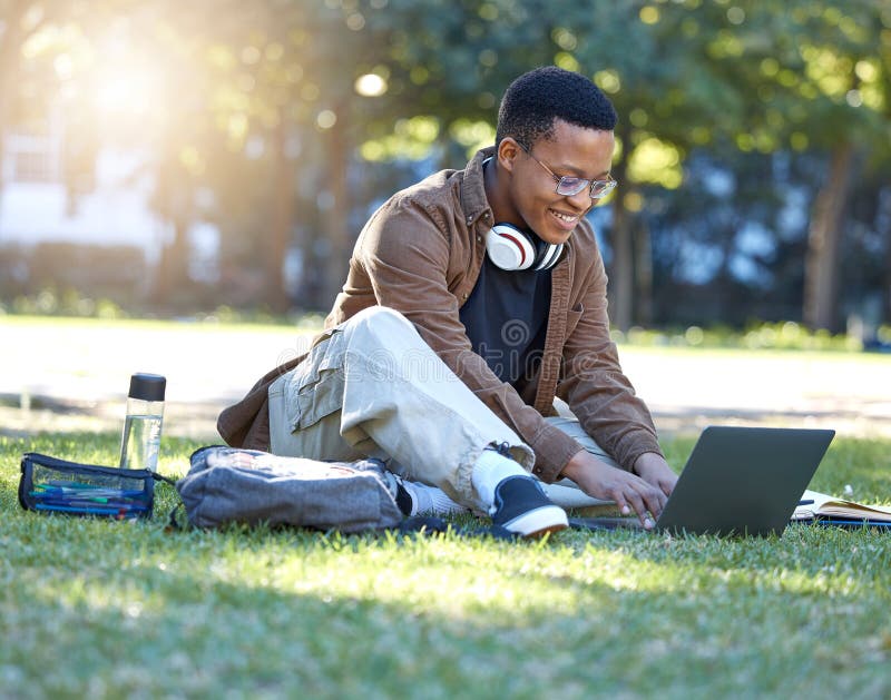 Black man, park studying and laptop work in a campus garden with a smile and lens flare, Outdoor, happiness and online