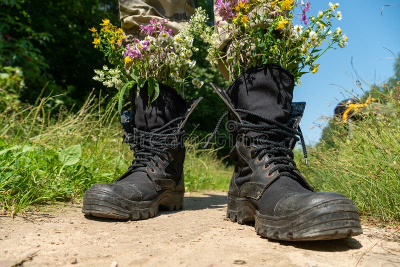 Black Military Boots with Flowers. Concept - Flowers instead of Bullets ...