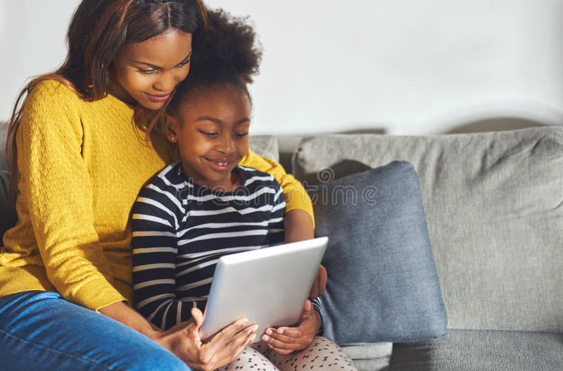 Black mom and child with tablet