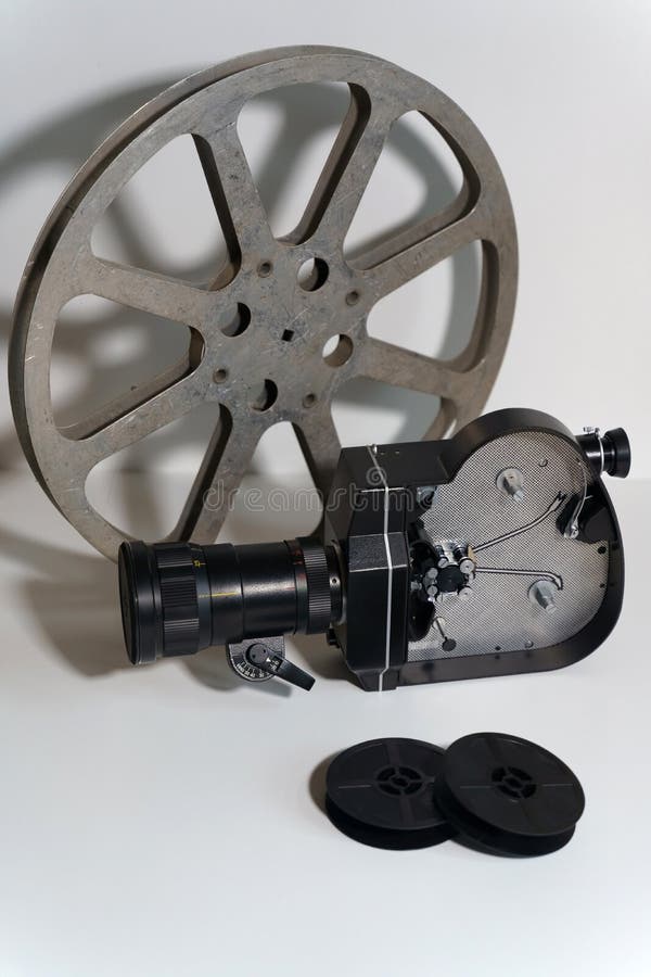 Black Movie Camera And Cassette Tapes On A White Background. Isolate
