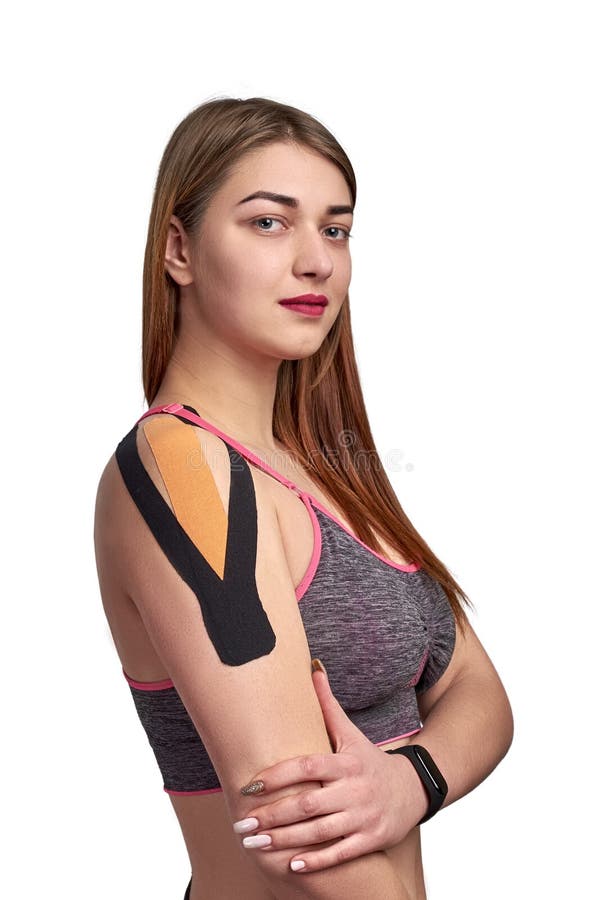 Black and orange kinesiotherapy tape on young sportswoman shoulder isolated on white