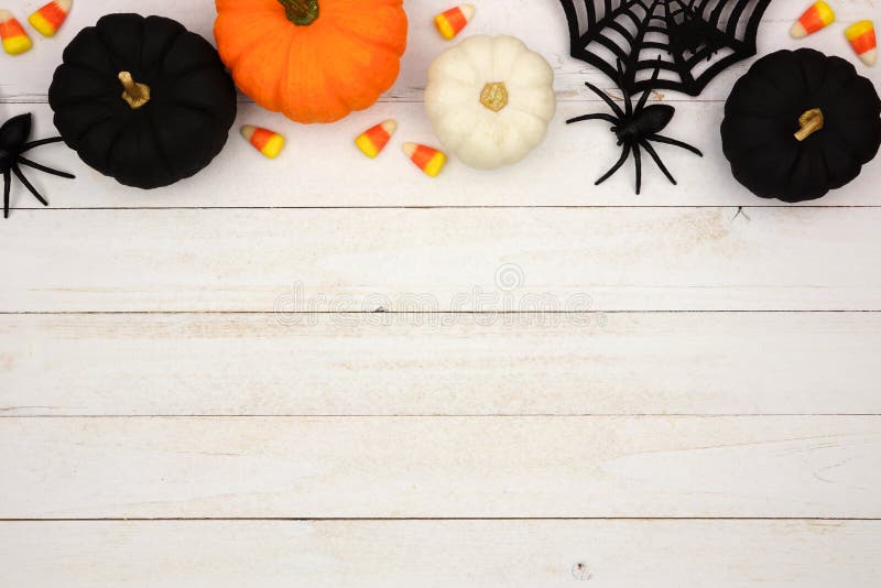 Black, orange and white Halloween top border over white wood