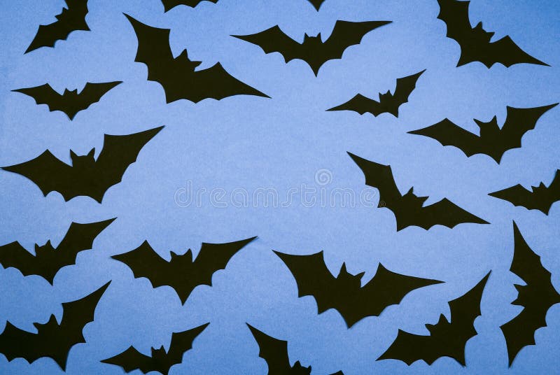 Black paper bats on a blue background.