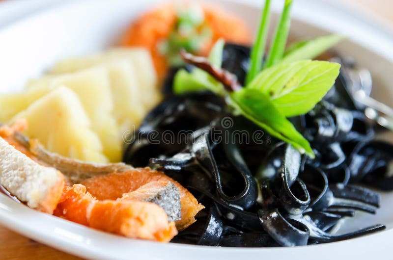 Black pasta spaghetti with smoked salmon Italian stock photo Black pasta spaghetti with smoked salmon Italian stock photo