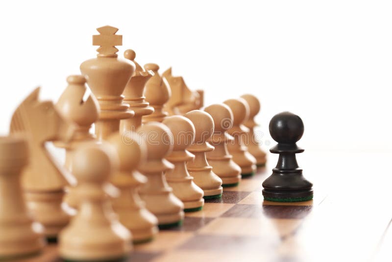 Black pawn challenging army of white chess pieces royalty free stock photography Black pawn challenging army of white chess pieces royalty free stock photography