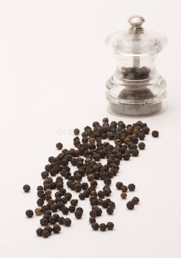 Black Peppercorns in a Pestle and Mortar and Ground Pepper Stock Photo