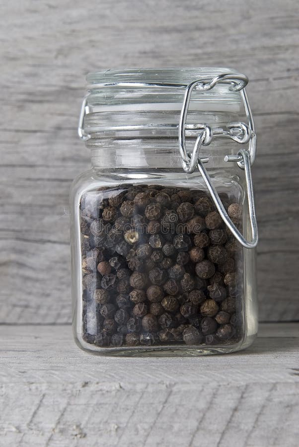 Black peppercorns in jar stock image. Image of flavoring 19253229