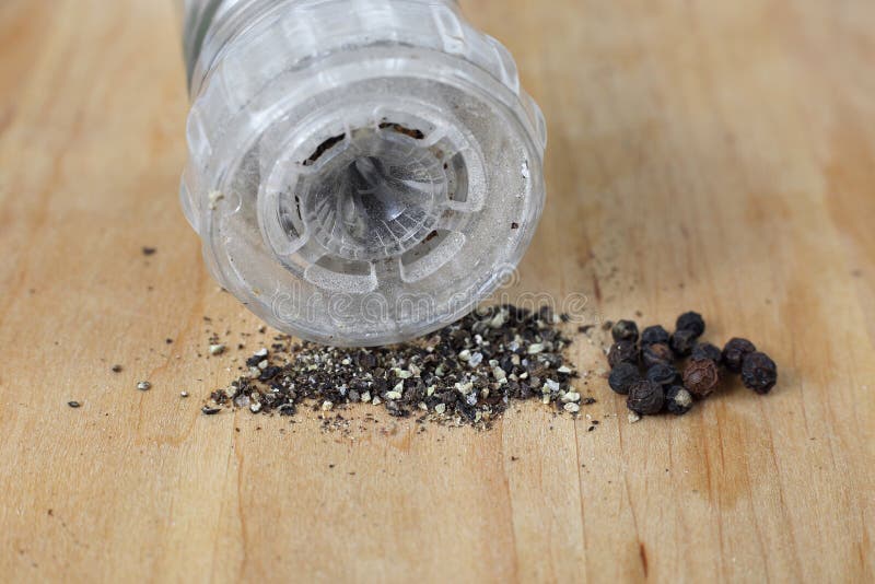 Black peppercorns and pepper from the mill