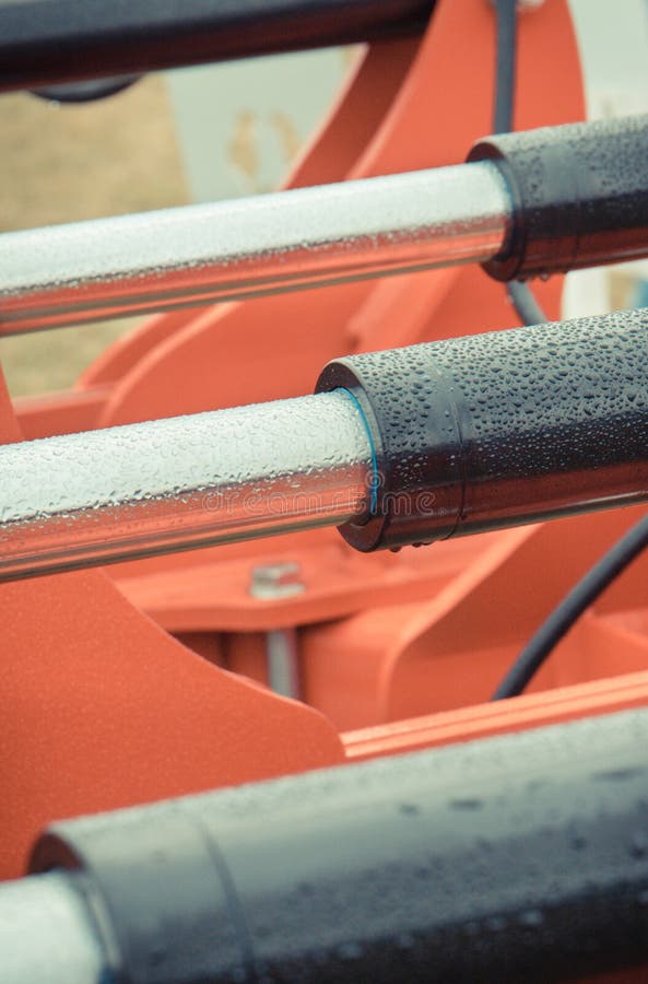 Black Pistons or Actuators in Red Pneumatic or Hydraulic Machine