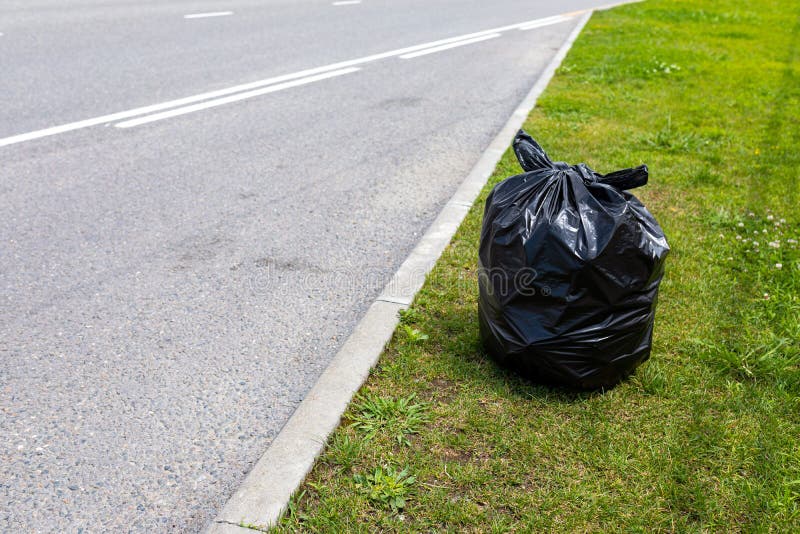 Black Plastic Garbage Bag on Side of Road Stock Photo Image of