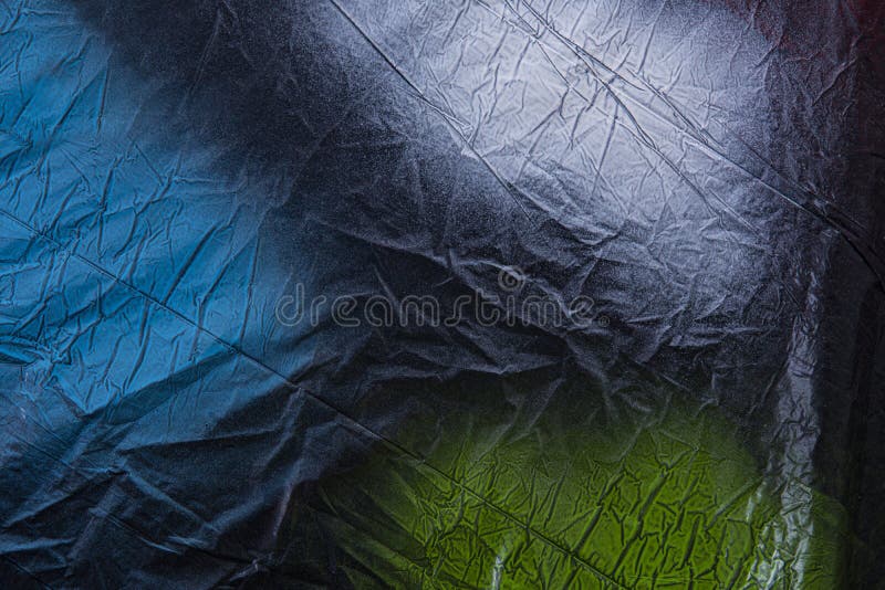 A Black Plastic Painted with Colored Spray Paint Blue, White and Green