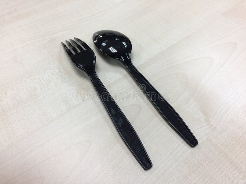Black plastic spoon and fork. Kids, clipping.