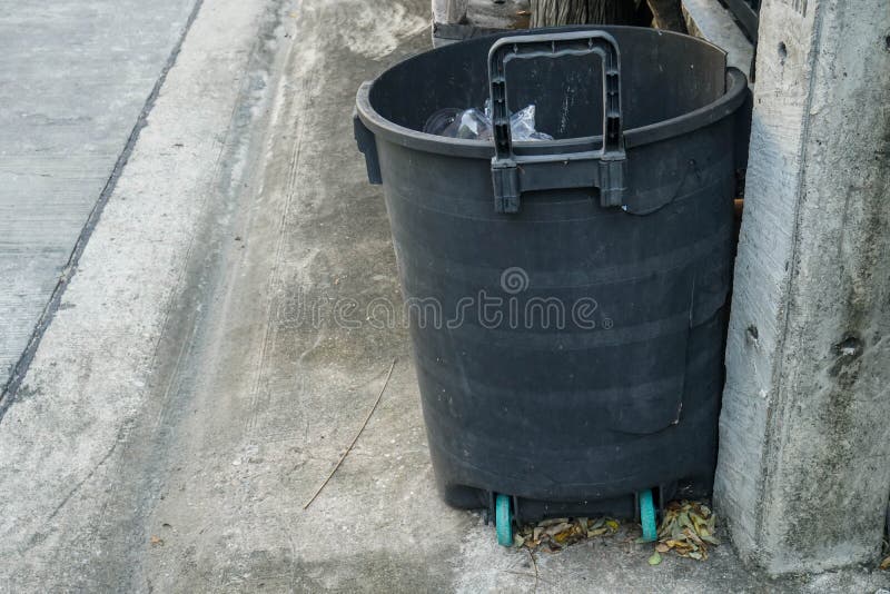Black Plastic Trash Bin in Front of the House Stock Image - Image of ...