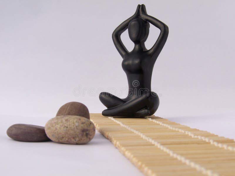 Black plastic women figure in lotus pose stock image