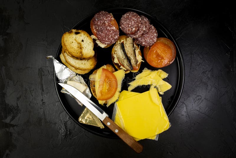 Black Plate with Sandwiches, Light Snacks for Beer, on a Black Stone