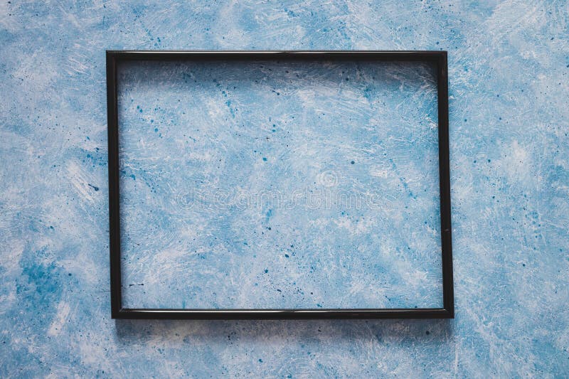 Black rectangular picture frame mock-up with copy space for yout text or image on top of hand painted blue background stock photo Black rectangular picture frame mock-up with copy space for yout text or image on top of hand painted blue background stock photo